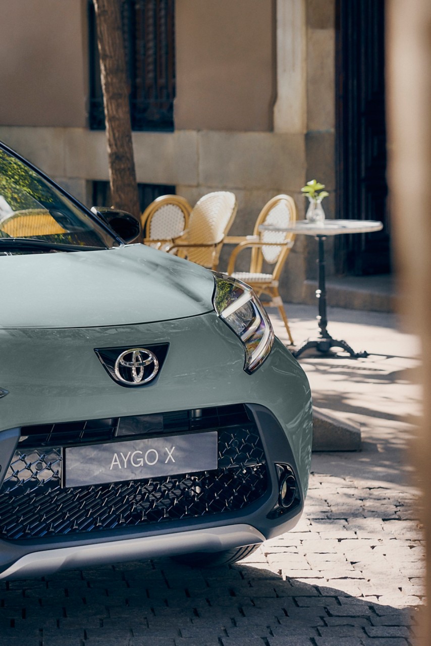 Image showing close up of Aygo X Tarragon Green front badge and lights